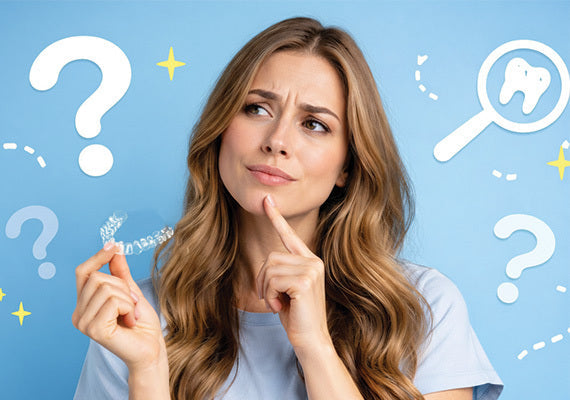 A girl holding aligners and thinking something