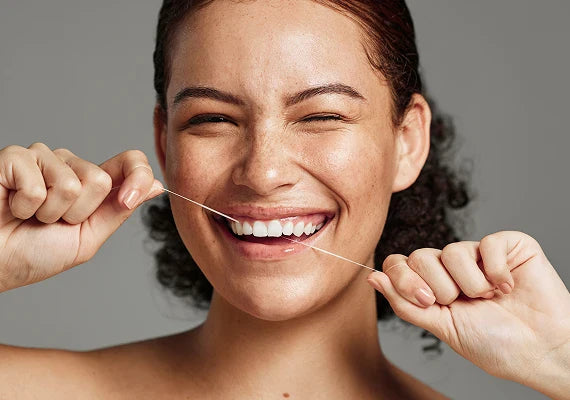 A girl flossing her teeth
