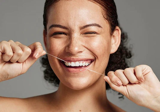 A girl flossing her teeth