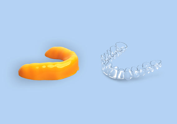A dental mouth guard and a clear retainer placed together.