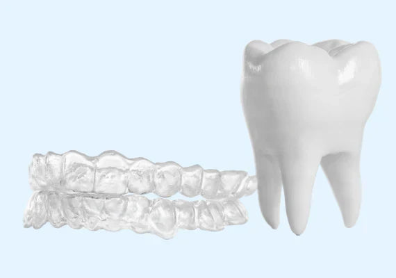 An image showing dental retainers and a tooth model.