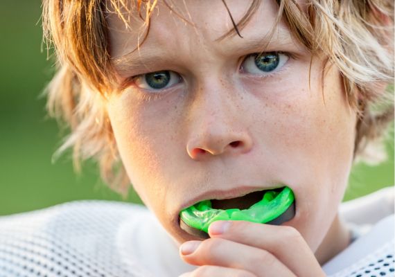 A close-up of a boy wearing a mouth guard before the game.