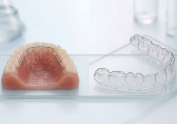 A side-by-side view showing a permanent retainer (with wire bonded to the back of the front teeth) and a clear removable retainer.