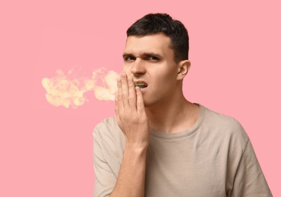 A guy checking bad breath after retainer use 