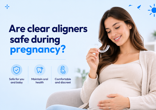 Pregnant woman smiling while holding a clear aligner.