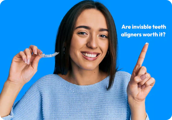 A girl smiling with aligners in her hand and text that says “Are invisible aligners worth it?