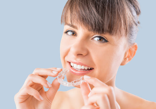 A girl applying clear aligners