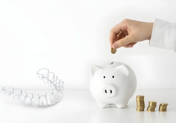 An image showing a piggy bank with clear aligners.