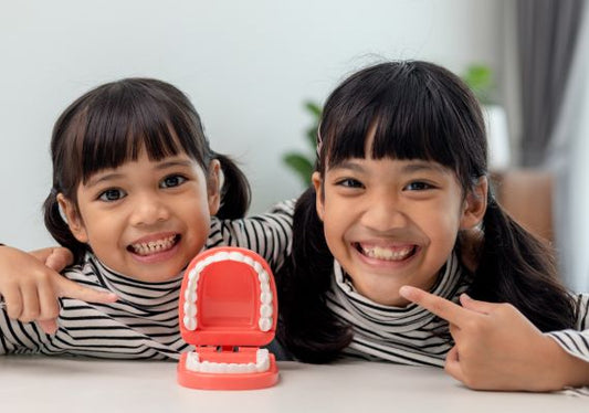two children with a dental model